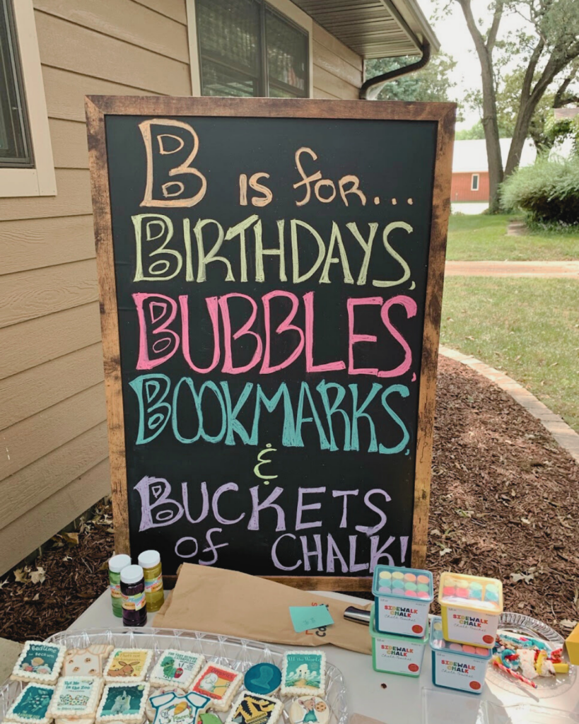 Board that says, "B is for... Birthdays, Bubbles, Bookmarks, & Buckets of Chalk".