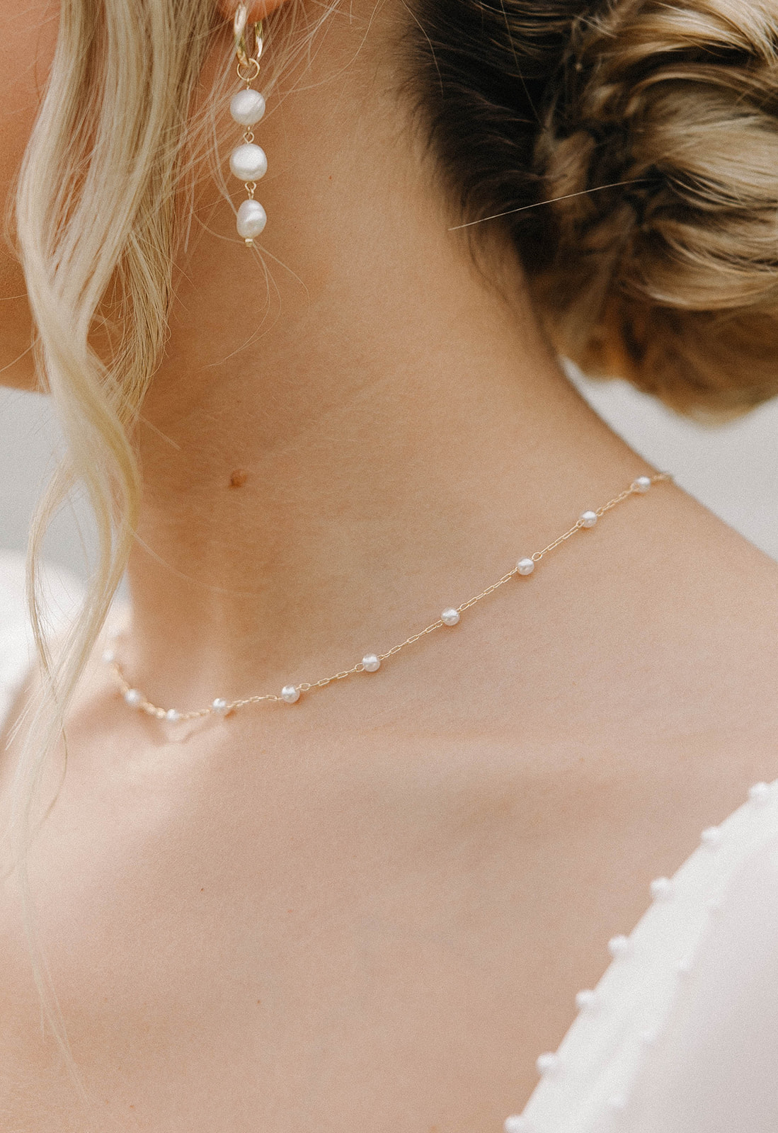 A close-up photo of a bride's necklace and earrings.