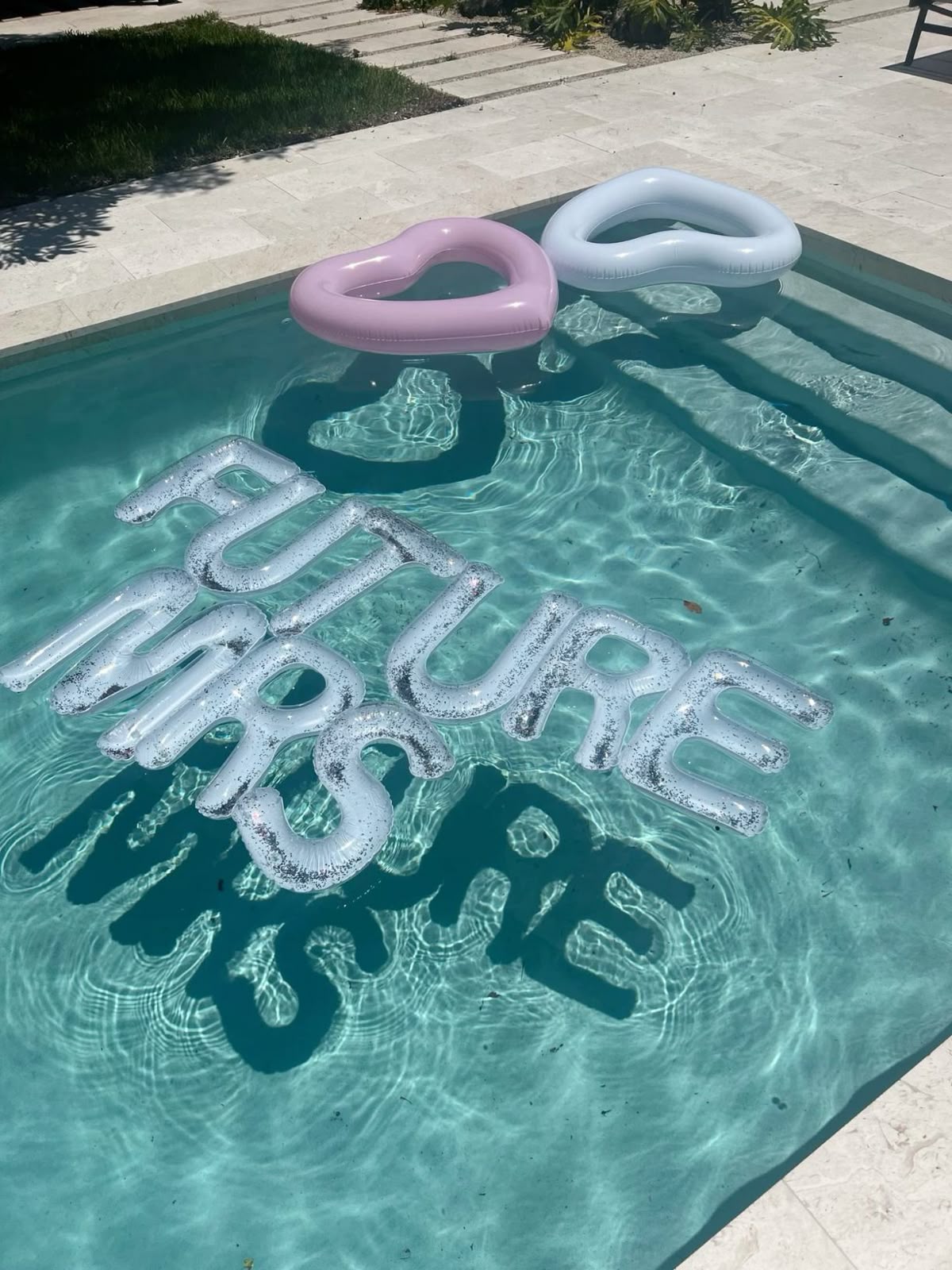 Future Mrs pool floats and heart floats in a bachelorette party pool