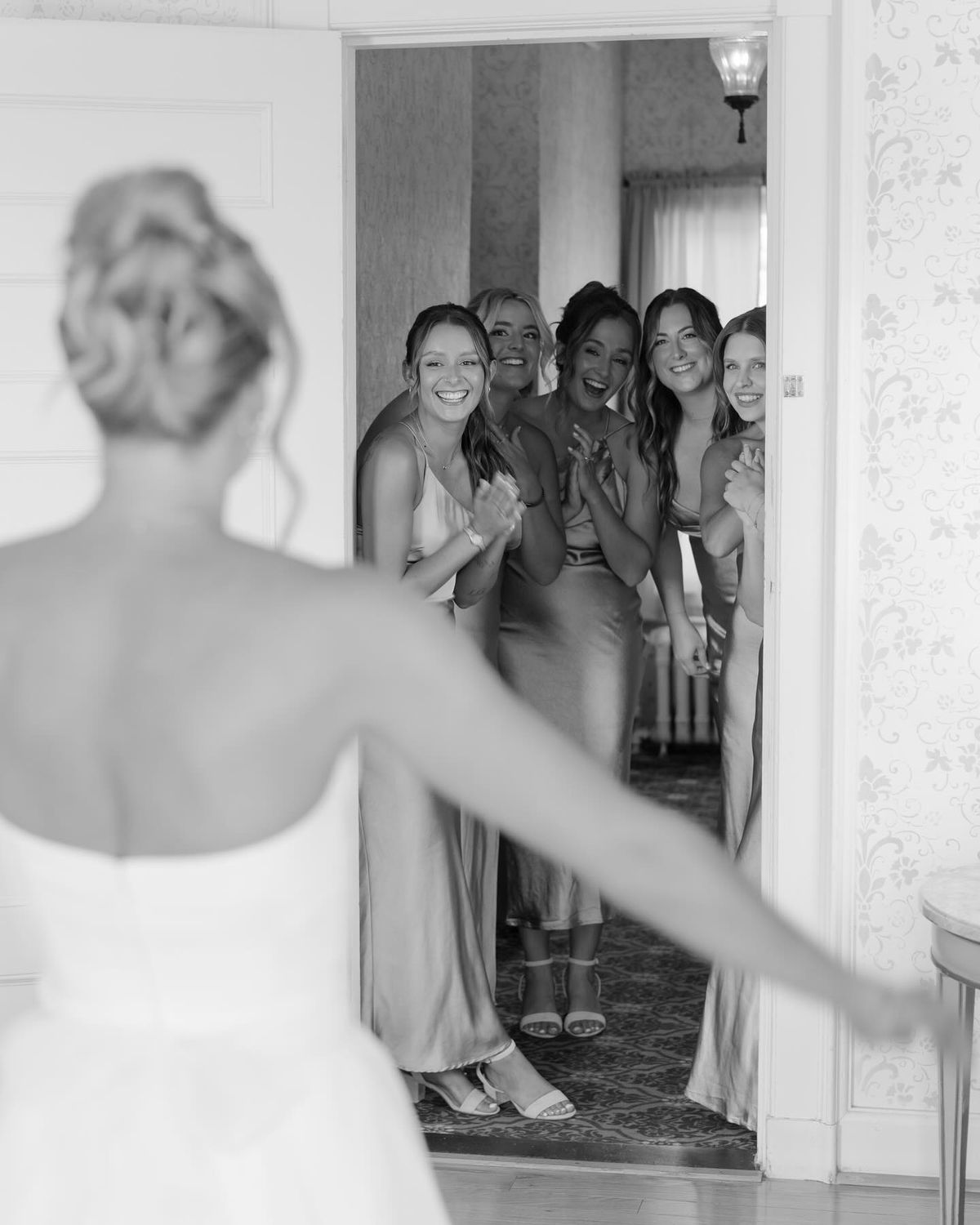 Bridesmaids reacting to seeing the bride in her wedding dress for the first time