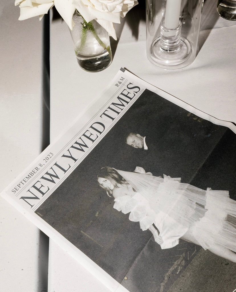 Newlywed Times newspaper favor on wedding reception table