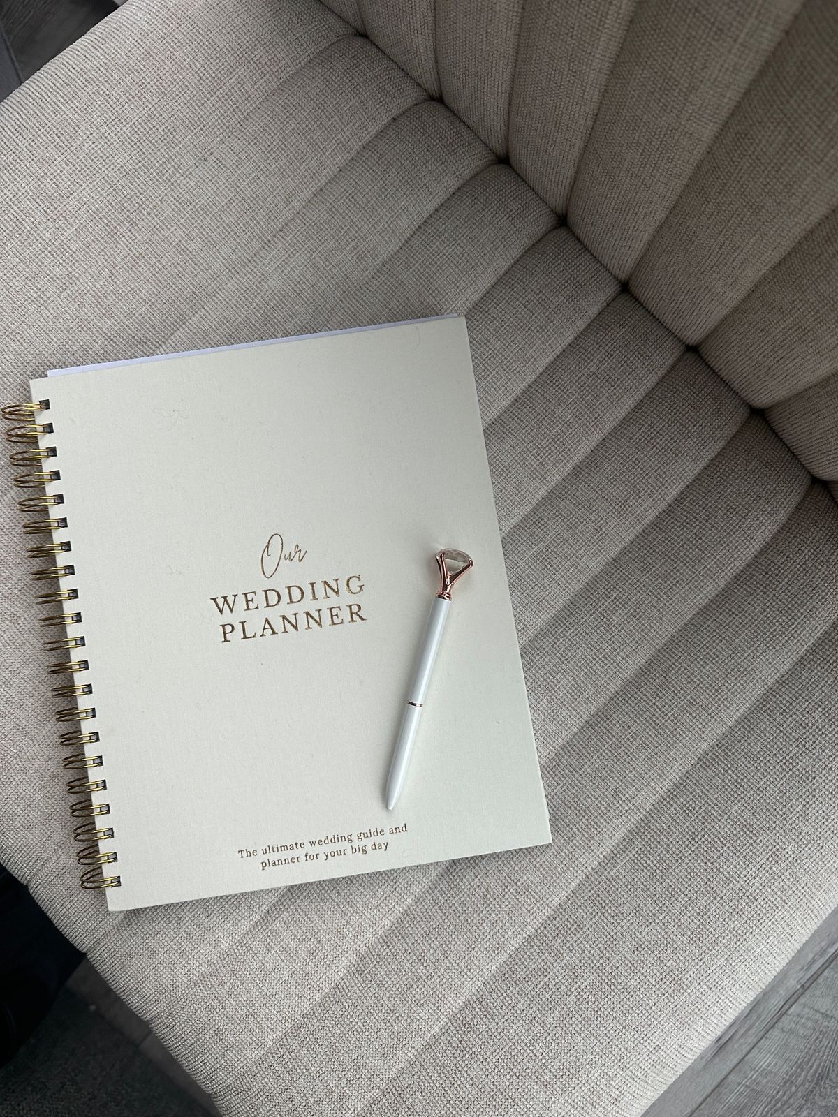 Wedding planner notebook and pen on a couch